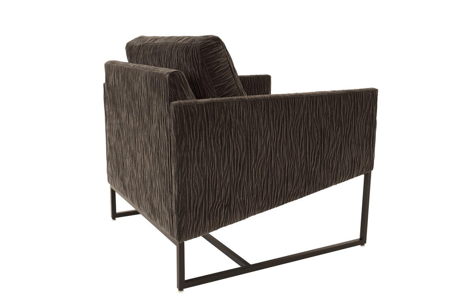 A brown Rebel lounge chair with angled side profile and metal frame, side and back view.