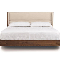 Sloane king size bed in American black walnut with a soft contemporary upholstered headboard and a floating design.