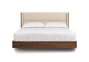 Sloane king size bed in American black walnut with a soft contemporary upholstered headboard and a floating design.
