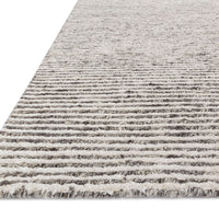 Hand loom knotted Valor Ivory/Natural Area Rug with patternless designs that are crafted of wool, viscose, and lyocell, featuring subtle and natural striations throughout the pieces.