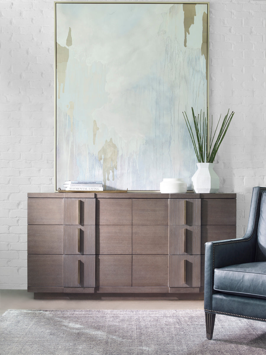Axis Six-Drawer Chest with classic Mid-century Modern and Art Deco design, placed in front of a white bricked wall.