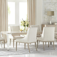 Marler storage cabinet placed in a dining room with a big dining table and six white dining chairs.