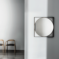 Square mirror with lacquered metal frame and burnished brass finish.