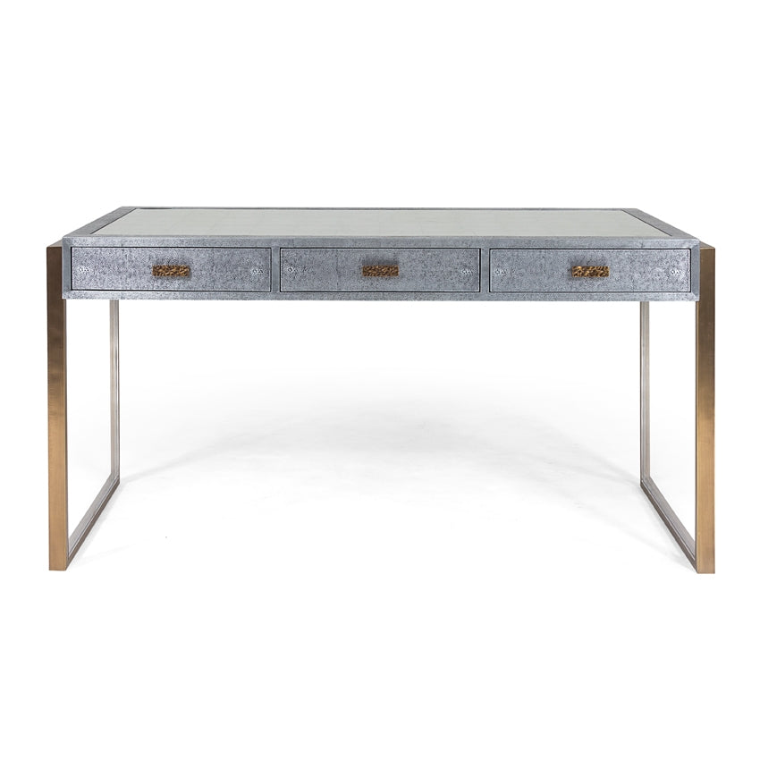 Brooklyn Desk finished in shagreen metal, supported by brass wrapped rectangular legs, and with three drawers.