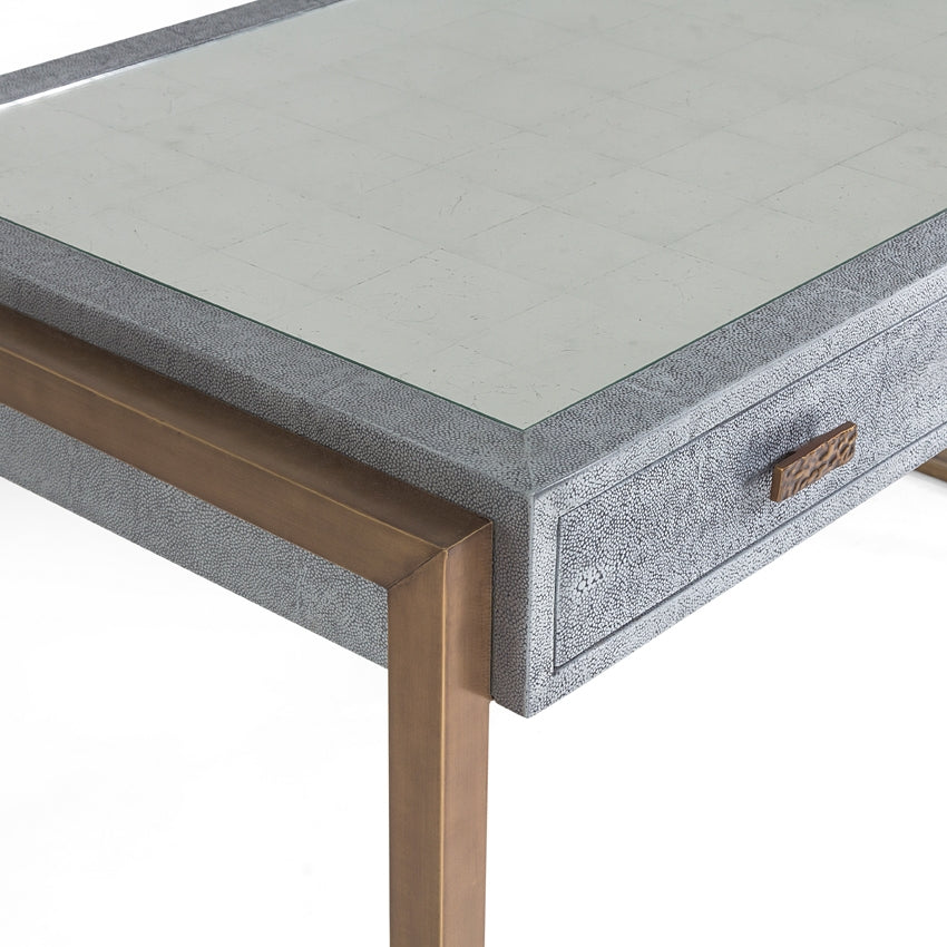 Brooklyn Desk finished in shagreen metal, supported by brass wrapped rectangular legs, and with three drawers. Closed up view on top and a drawer.