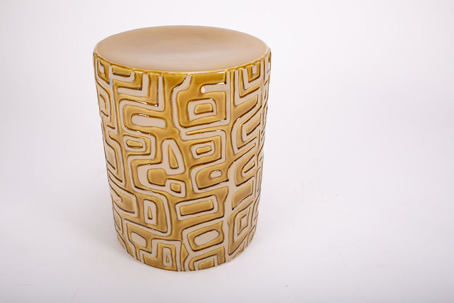 Loman Side Table made from natural clay in cylindrical shape with raised patterns. Closed up top view.