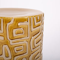 Loman Side Table made from natural clay in cylindrical shape with raised patterns. Closed up top view.