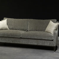 Grey two seat Fisher sofa with soft curved outside back, wood perimeter detail and casual comfort.