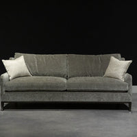 Grey two seat Fisher sofa with soft curved outside back, wood perimeter detail and casual comfort.