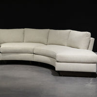 White curved Clip Sectional with the wood legs. Side view.