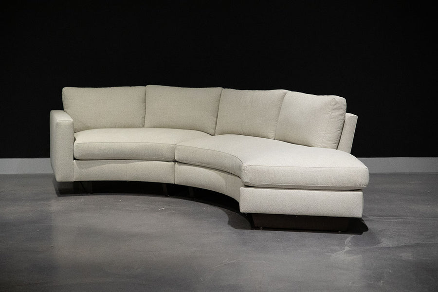 White curved Clip Sectional with the wood legs. Side view.