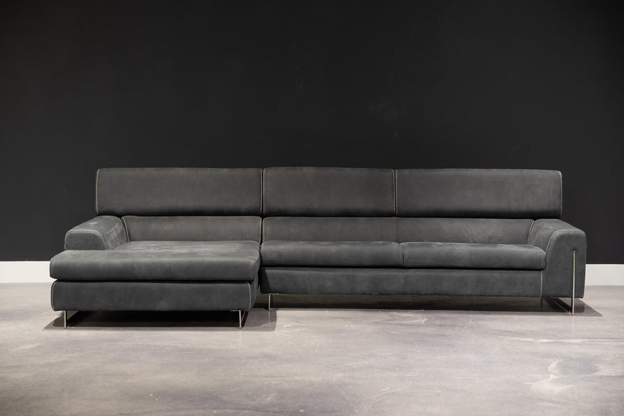 Black leather Bellevue Sectional with minimal lines and an original metal base that slots into the armrests.