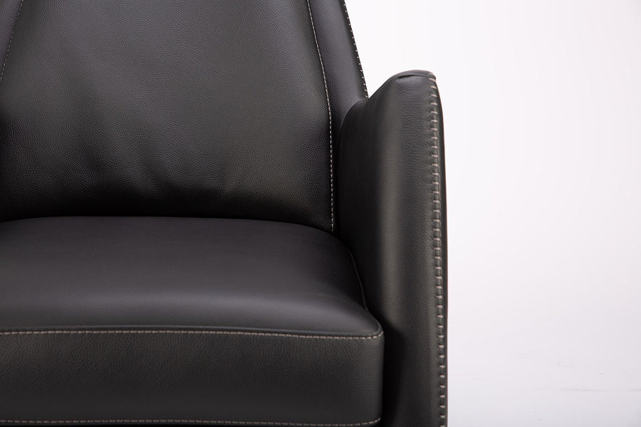 A black leather Kate swivel armchair. Closed up front view.
