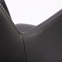 A black leather Kate swivel armchair. Closed up back view.