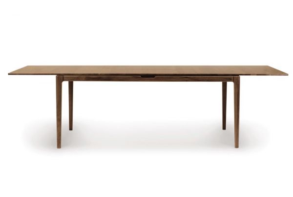 Lisse Extension dining table crafted in solid American black walnut hardwood with natural finish and with a single self-storing butterfly leaf for single handed operation.