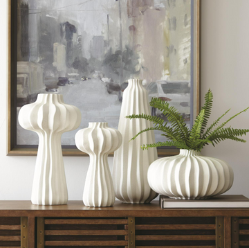 White, hand-crafted Lithos four Vase Collection with irregular ridges that accentuate the three organic shapes.