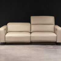 White leather two seat Turin sofa with splayed metal legs and power mechanism that operates the headrest and footrest independently