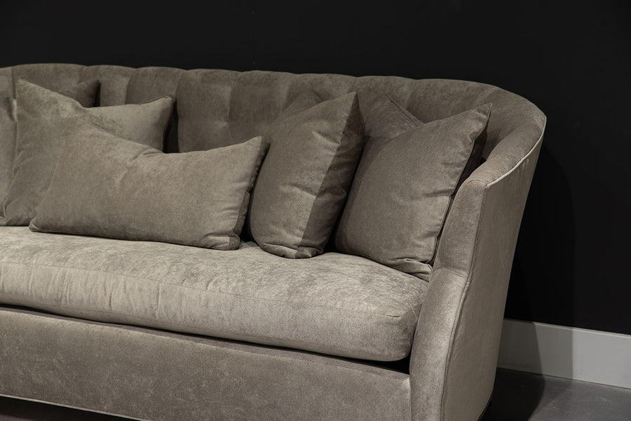 Light grey Luccia Sofa with subtle pin tufting on the inside back, comfortable bench seat, double-stitch back and high, curved arms. Closed up view.