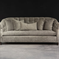 Light grey Luccia Sofa with subtle pin tufting on the inside back, comfortable bench seat, double-stitch back and high, curved arms.