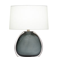 Nellie Table Lamp with a bold oval base, sophisticated polished nickel finish and off-white linen shade.