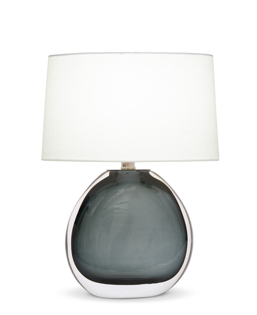 Nellie Table Lamp with a bold oval base, sophisticated polished nickel finish and off-white linen shade.