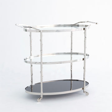 Arbor 3 level Bar Cart with twig textured detailing on the supports and handles, a solid white marble bottom shelf, and two glass upper shelves with solid brass pivoting wheels.