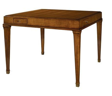 Julien Game Table crafted in solid maple with fine anegre veneers with a small drawer positioned near the left corner on all four sides and tapered legs that are topped with antique brass collars