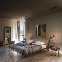 The Nelson designer modern king size bed with a light shape, placed in a modern room, front and side view.