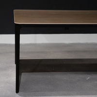 Left side of Slim Dining Table with die cast aluminum legs and wooden top.