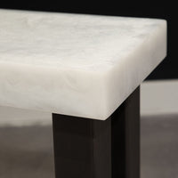 Modern console table with white top and black legs, closed up view.
