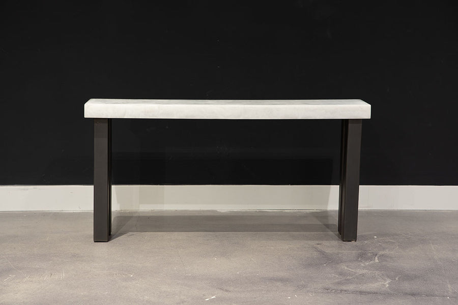 Modern console table with white top and black legs.