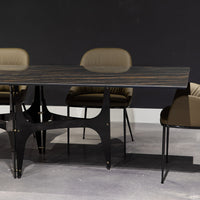 Fixed rectangular Universe Dining Table with lacquered metal frame and decorative details and with anti-scratch SuperMarble top. Placed in a room with three leather dining chairs.