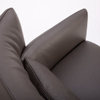 Dark brown leather Tulip swivel armchair, endowed with a lower-back cushion. Closed up top view.