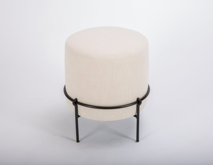 White Amalie Ottoman with delicate forged iron stands and the round form.