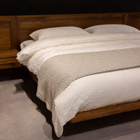 King size Moduluxe bed with modular headboard and nightstands with a floating look in wood colors, side and front view.