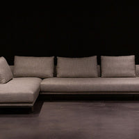 Light grey Quinta Strada Sectional with black chrome finish of the feet, the thinner joining clamps, and light base and back support.