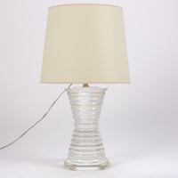 Andre table lamp with a shaped crystal base in a conical design and a white shade.