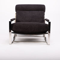 Dark grey Cruisin lounge chair with a brushed bronze frame, cylindrical headrest and padded arms combined with the luxurious seat and back, front view.