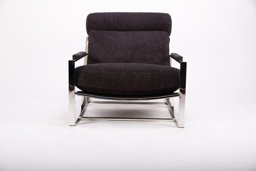 Dark grey Cruisin lounge chair with a brushed bronze frame, cylindrical headrest and padded arms combined with the luxurious seat and back, front view.