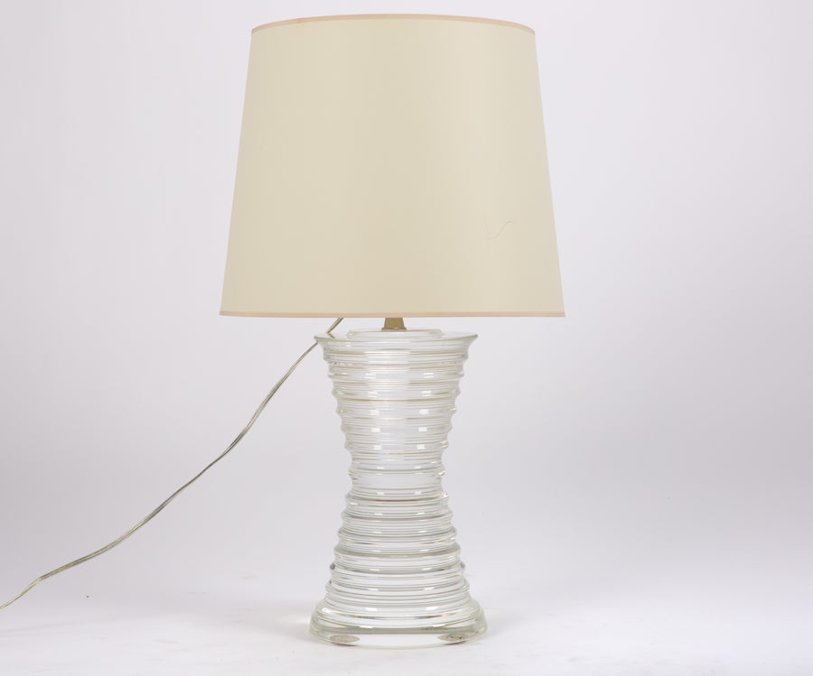 Andre table lamp with a shaped crystal base in a conical design and a white shade.