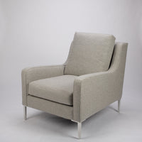 A light grey mid size lounge chair with classic shape and white legs. Front and side view.