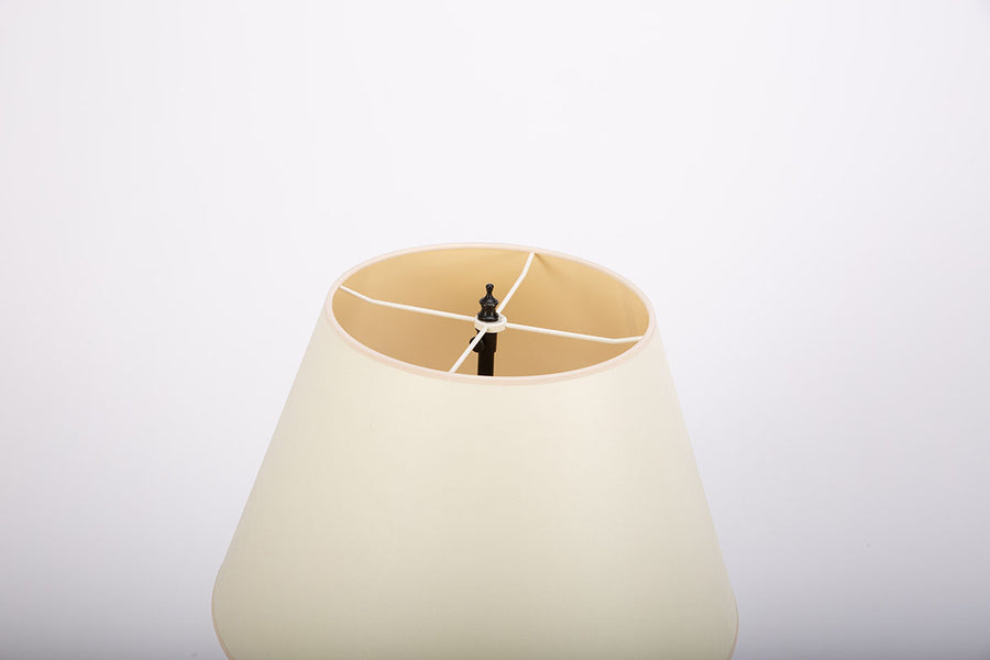 Yul table lamp with cylindrical brass plates applied to create a simple clean, industrial form. Closed up view on the shade.