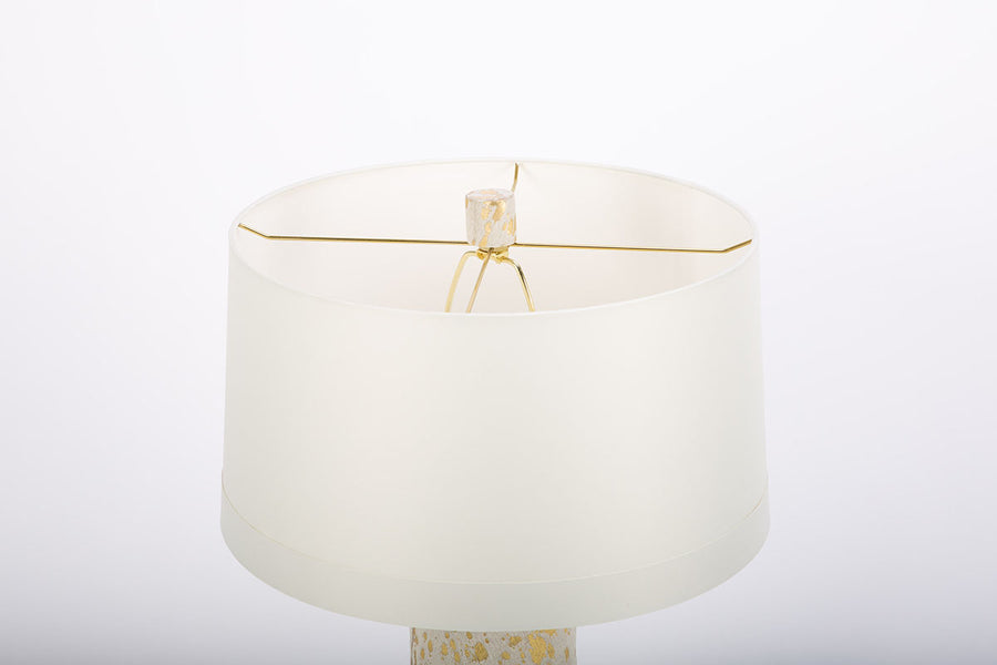 Hand crafted Sheena lamp with acid etched pattern and gold leaf finish on hide and with white drum shade. CLosed up view on the shade.