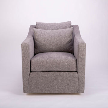 A light grey Rebecca Swivel lounge Chair with compact scale, gentle curves and supporting comfort of the double pillow back.