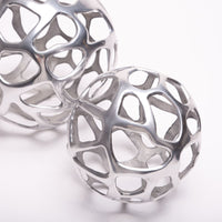 A big and a small Ennis Web Whimsical Spheres made from antique silver.