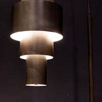 Black Babylon Floor Lamp with formed of bold concentric circles and with floor switch on cord. Closed up view on lamp.