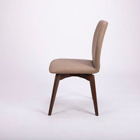 A beige Hexa swivel dining chair with wood base. Side view.