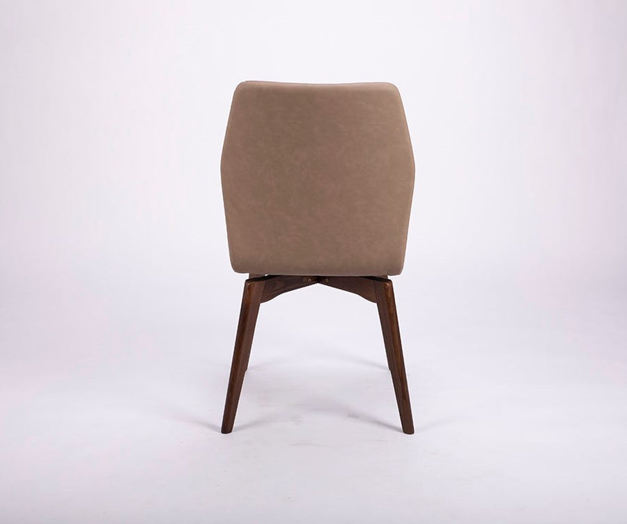 A beige Hexa swivel dining chair with wood base. Back view.