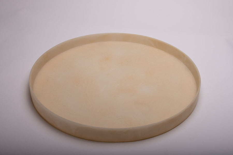Round Boulevard Tray in linen marble and with low edges and an effortless disposition.