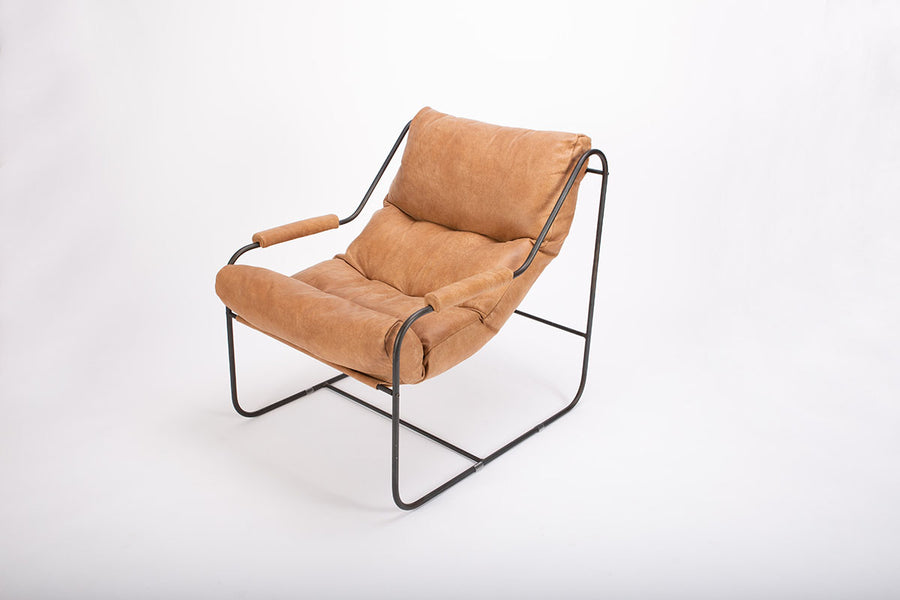 Brando contemporary lounge chair with industrial metal frame with a reclined back and plush feather down fill. Front and side view.